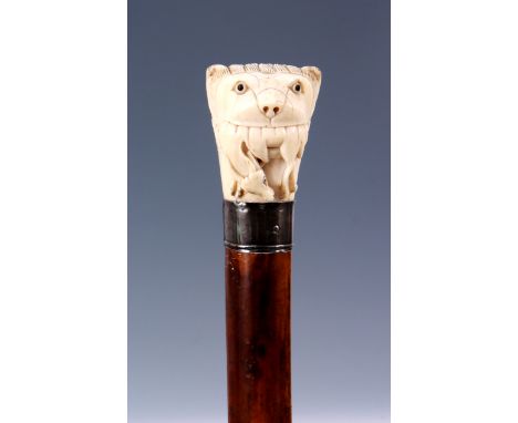 AN EARLY 19TH CENTURY OVERSIZED INDIAN IVORY HANDLED MALACCA WALKING STICK the handle formed as a lion’s head with antelope i