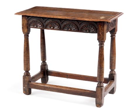 AN 18TH CENTURY JOINED OAK SIDE TABLE OF SMALL SIZE with moulded edge top above a three-quarter carved top rail; standing on 