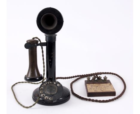 AN EARLY CANDLESTICK TELEPHONE with enamelled number dial and bakelite earpiece, the base with bulb for call indicator, cords