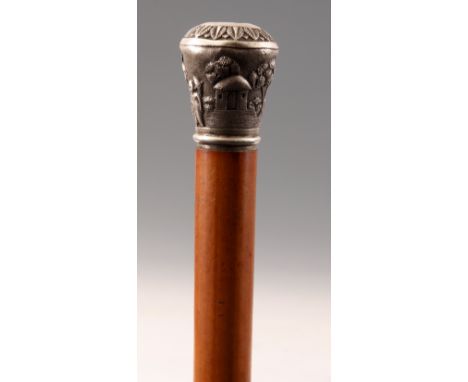 A LATE 19th CENTURY SILVER HANDLED MALACCA WALKING STICK decorated with figures in a garden setting.