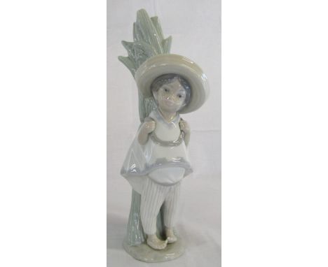 Lladro figure of a Mexican boy stood next to cactus