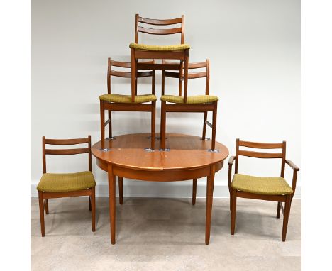 1970's circular teak dining table with fold out extension leaf &nbsp;plus 5 chairs (one a carver) with padded seats in green 