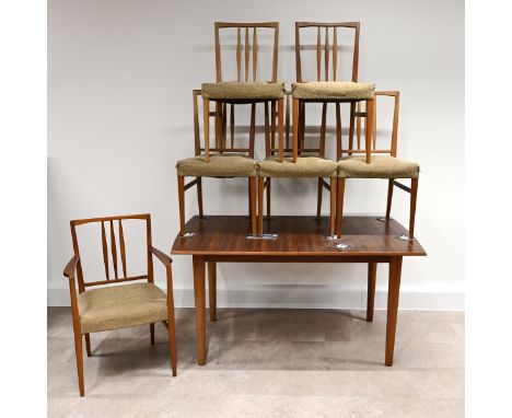 A Mid-Century Gordon Russell for Heals teak extending dining table and 6 chairs (one of which is a carver) with padded fabric