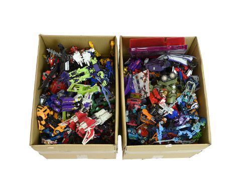 A large collection of vintage and modern Transformers figures and accessories