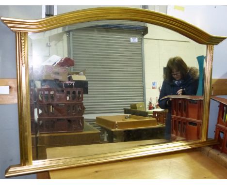 A Victorian style over mantel mirror in gilt frame with arch top