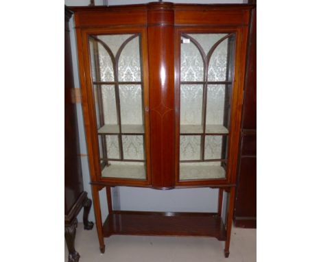 An Edwardian Sheraton style mahogany inlaid display cabinet with double doors and shelf under