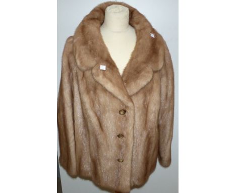 A honey coloured mink jacket with 3 button front detail