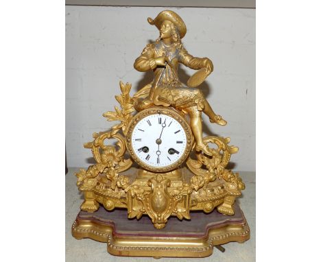 A 19th century French ormolu mantel clock surmounted by a seated cavalier with artist's equipment, striking French drum movem