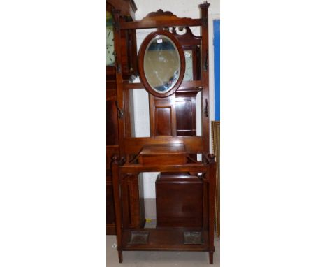 An Edwardian oak hallstand with glove drawer and twin stick compartments, 29½"