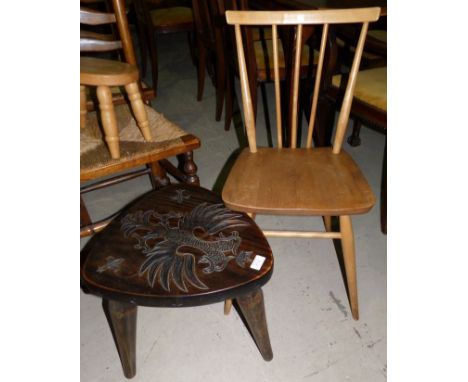 A carved oak triangular occasional table; an Ercol stick back dining chair