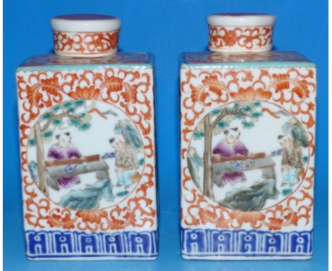 A pair of "Chinese Imari" square caddy shaped covered vases decorated with circular polychrome cartouches depicting figures i