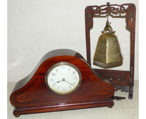 A Chinese brass bell on hardwood stand; a 1920's inlaid mahogany mantel clock; a carved wood elephant