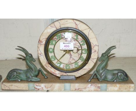 An Art Deco variegated circular mantel clock with 2 bronzed antelope