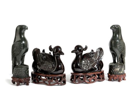 A PAIR OF CHINESE AMBER STYLE TUFTED DUCKS 20TH CENTURY modelled squatting on the ground, on pierced hardwood stands, togethe