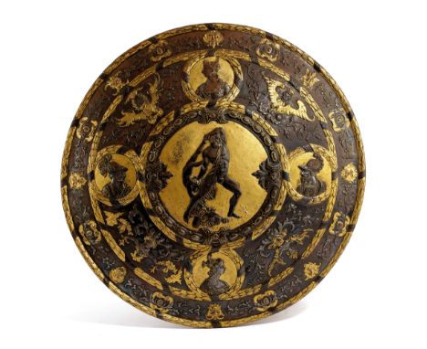 AN EMBOSSED STEEL AND GILDED PARADE SHIELD IN RENAISSANCE STYLE, 19TH CENTURY of convex circular form, the centre with a depi