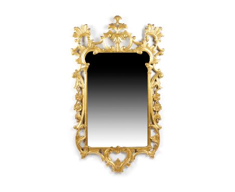 A GILTWOOD WALL MIRROR IN GEORGE II STYLE, 19TH CENTURY the shaped plate within a frame carved with 'C' scrolls, leaves and f