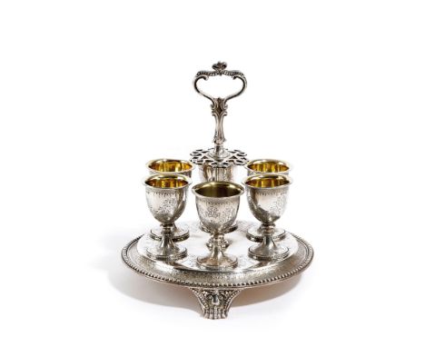 A VICTORIAN SILVER SIX EGG-CUP CRUET FRAME BY ROBERT HENNELL, LONDON, 1863 of circular form, with a central scroll carrying h