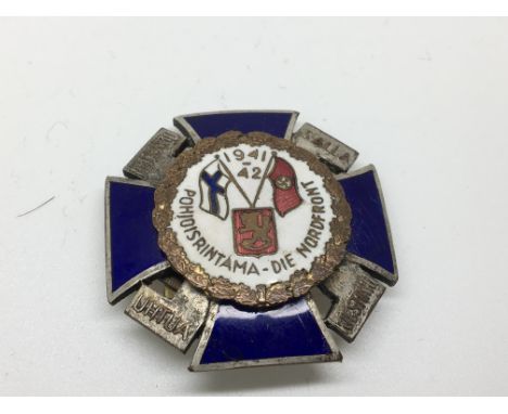 A 1941-42 Finland enamel badge Nordfront decorated in enamel with German Third Reich  and Finland Flag.