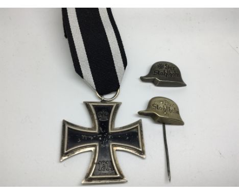 A German Imperial iron cross and two German I World War Stick pins