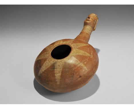 20th century AD. A ceramic gourd vessel with central hole to the upper face, tapering handle with human mask finial, starburs