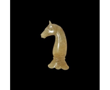 Late 19th-20th century AD. A carved jade(?) dagger handle formed as a horse's head and neck, flared socket below with rosette