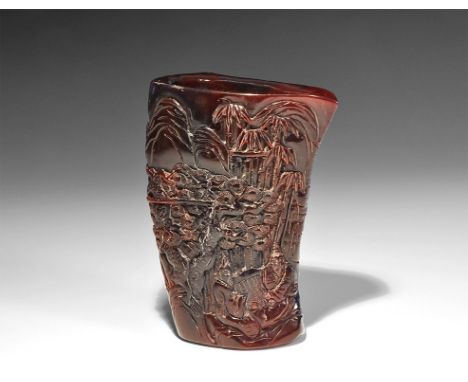 20th century AD. A moulded composition brush holder with high-relief scenes to two faces depicting a seated figure among vege
