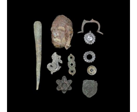 16th-19th century AD. A group of objects consisting of: two pewter sun burst medals; a bronze strap fitting in the shape of a
