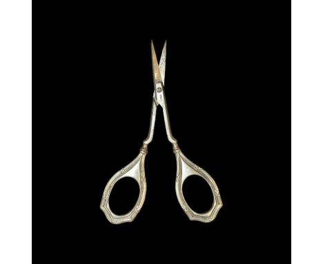 19th century AD. A pair of Victorian nail scissors with curved blades; fitted with repoussé silver handles of Art Nouveau sty