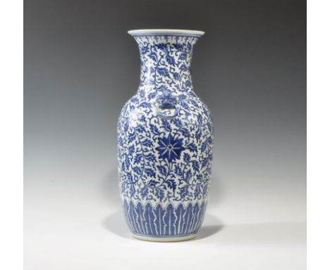 20th century AD. A tall tin-glazed ceramic jar with piriform body, broad everted rim, two lion-masks to the shoulders each wi