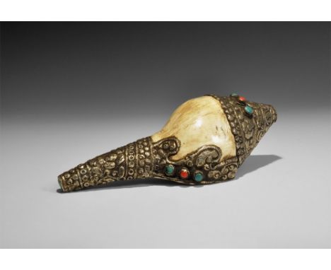 20th century AD. A large conch shell with silver-coloured metal mounts to the mouth and both ends, decorated with a repoussé 