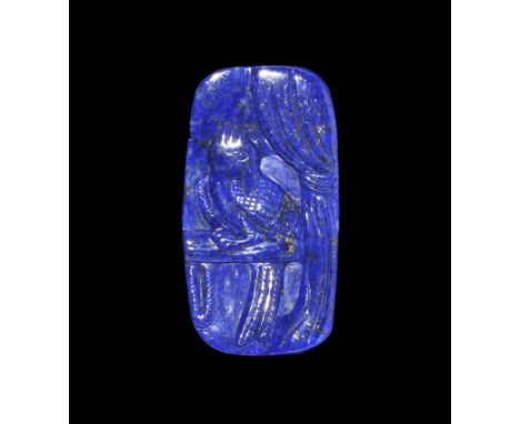 20th century AD. A rectangular lapis lazuli panel with carved image of a bird on a perch with curtain to one side, mountains 