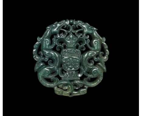 20th century AD. An openwork glass pendant of two serpentine dragons flanking a panel with grotesque facing mask. 45 grams, 7