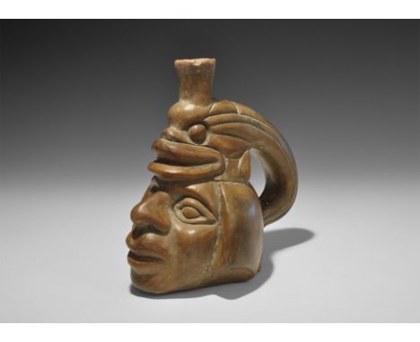 20th century AD. A ceramic vessel formed as a human head with piscine headdress, handle formed from the fish's body, funicula
