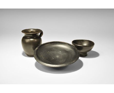 4th century BC. A mixed group of blackware ceramic vessels comprising: a dish with chamfered rim and flared foot; a bowl with
