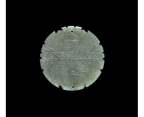 19th-20th century AD. A carved bifacial discoid nephrite pendant with notched rim, incised low-relief detailing of a cicada w