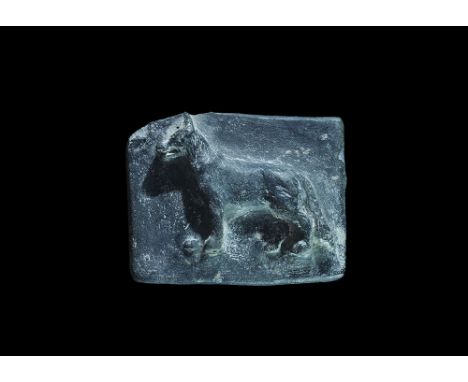 20th century AD. A rectangular ceramic block with high-relief image of a standing canine. 68 grams, 62mm (2 1/2"). Property o