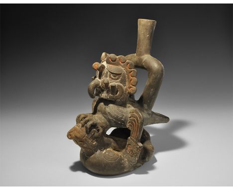 20th century AD. A ceramic stirrup jar formed as a bird of prey attacking a a coiled serpent. 1 kg, 29cm (11 1/2"). From an o