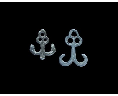 9th-10th century AD. A pair of bronze hanger mounts, each a pierced trefoil with vertical shank and returned hooks. 12 grams 