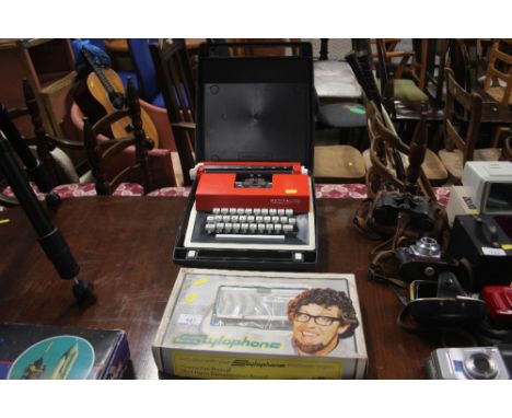 A Rolf Harris stylophone; together with a small typewriter in carrying case