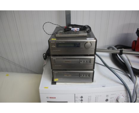 A Denon stack stereo receiver; stereo cassette deck and a compact disk player with remote control
