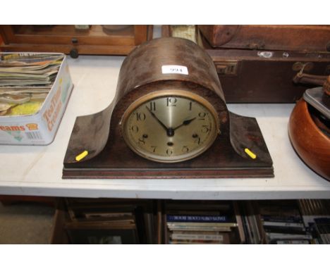 An oak cased three holed mantel clock