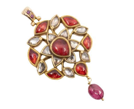 An Indian Kundan pendant set with Polki diamonds, fancy shaped garnet cabochons, small faceted rubies and a ruby drop. The st
