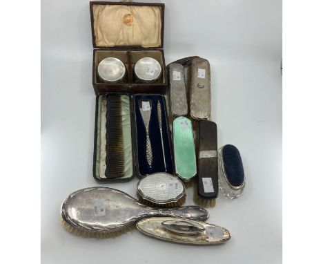 A pair of circular brushes with silver mounts, Birmingham 1925, cased, a hairbrush and three clothes brushes, all with silver