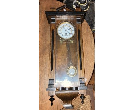 7. Vienna wall clock with 8 day single train spring driven movement with 5" two piece dial. Roman numerals. Dimensions 29" x 