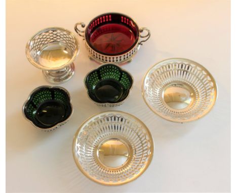 A ruby glass small dish with pierced silver twin handled mount, bun feet, Sheffield 1908, a pair of pierced silver shaped cir