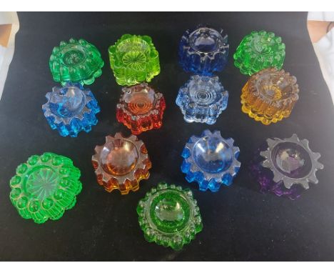 A collection of heavy coloured pressed glass furniture caster cups or floor / carpet protectors, in&nbsp; various colours&nbs