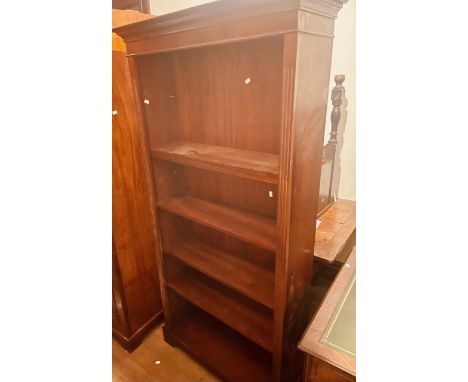 A Chippendale revival mahogany open bookcase, dentil cornice above adjustable pin-fitted shelves, raised on a plinth base. 18