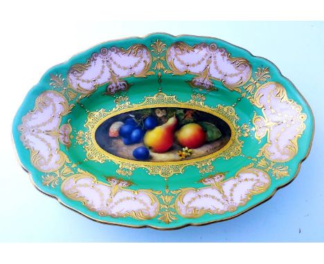 A Royal Worcester oval dish, c1900, painted with pears and grapes by R. Seabright within a peach and green tooled gilt border