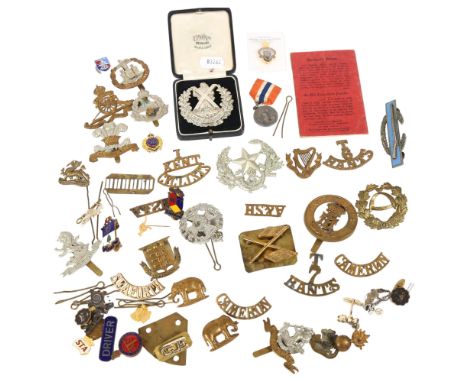 Assorted Regimental badges, and a Malaya swimming medal and a Cameroon badge inscribed 10743 1914 Private J R Shipsey, camp o
