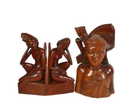 A pair of carved Balinese bookends, and a Balinese hunter bust by Fatimah, Bali, all signed to base, tallest 34cm 